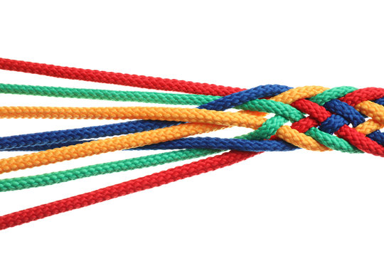 Braided colorful ropes on white background. Unity concept Stock Photo