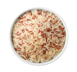 Mix of brown and polished rice in bowl isolated on white, top view