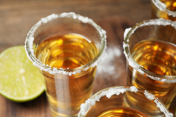 Mexican Tequila shots with salt on table, closeup
