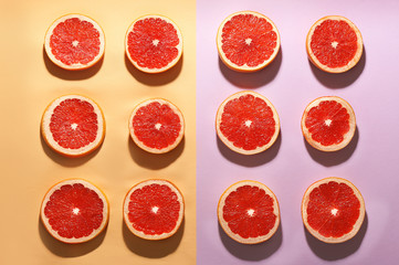 Flat lay composition with tasty ripe grapefruit slices on color background