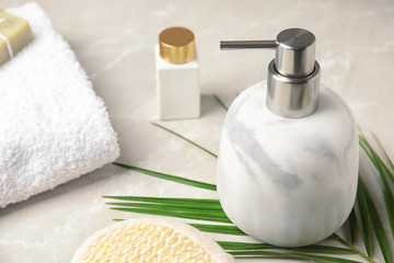 Modern marble soap dispenser on light table