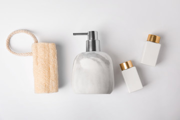 Flat lay composition with marble soap dispenser on white background