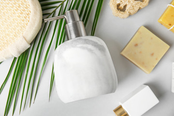 Flat lay composition with marble soap dispenser on white background