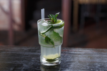 Horizontal view. Fresh mojito cocktail in freeze motion splashing, close-up.