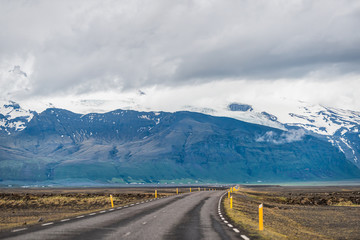 Iceland mountains view from ring road trip highway and snowcapped mountain cliff on cloudy day near Hof and Skaftafell national park