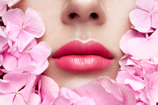 Close up view of beautiful woman lips with pink lipstick