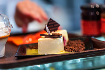 Closeup of chocolate dessert custard pastry on tray display in bakery shop store in Florence, Italy in famous market