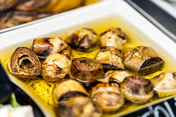 Marinated grilled artichokes vegetables in olive oil in market shop grocery display in Florence Italy macro closeup