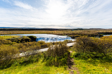 Faxafoss Faxi waterfall landscape with trail path walkway in south Icelandwater falling flowing on Golden Circle in autumn season wide angle view