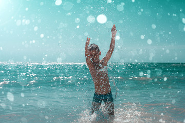 a child running on the seashore with waves