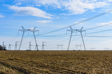 High voltage power line in a field on autumn