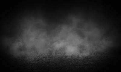 Dark street, wet asphalt, reflections of rays in the water. Abstract dark blue background, smoke,...