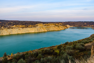 Obraz premium Lake with sandy bank in the abandoned coal quarry