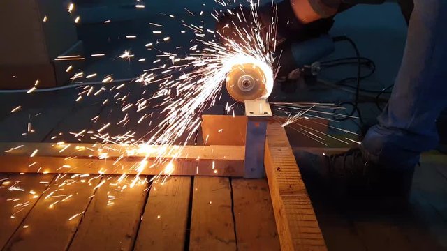 Welder at work with circular blade.