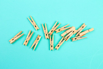 wooden cloth pegs on blue  background .