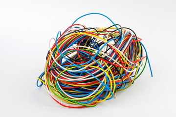 harness of power electrical wires of different colors on the white background of the table