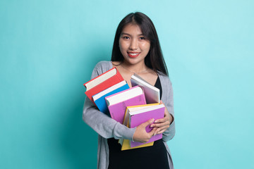 Young Asian woman studying  with may books.