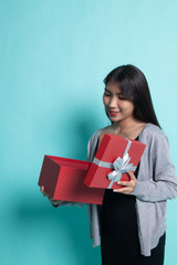 Young Asian woman open a gift box.