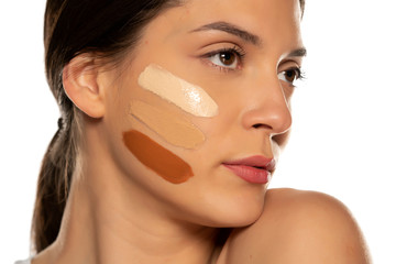 Young woman with three different tones of liquid foundation on her face