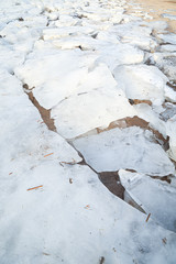 Fototapeta premium cracked ice on the shore
