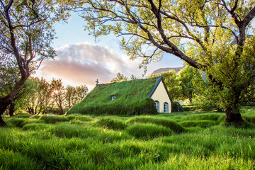 Charming mystical scene with turf roof church in old Iceland traditional style and mystical...