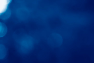 image of summer blur background toned in trendy Classic Blue color of the Year 2020