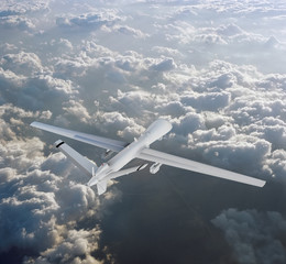 military RC military drone flies flies against backdrop of beautiful clouds on blue sky background. Elements of this image furnished by NASA