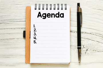 Agenda text on notepad - business concept