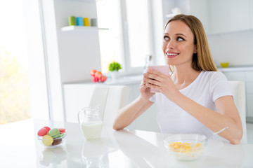 Photo of dreamer housewife holding hot beverage breakfast cornflakes healthy eating dieting looking dreamy imagine herself chin sitting table white light kitchen indoors