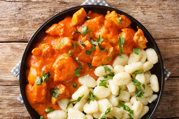 tender pieces of chicken in a fragrant creamy sauce, this Chicken Paprikash closeup on a plate. Horizontal top view