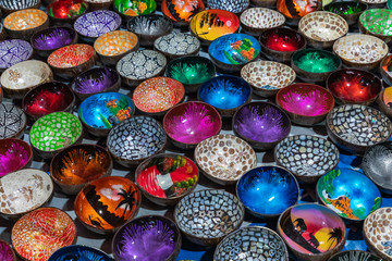 Fototapeta na wymiar Souvenir colourfully lacquer bowls on the market at Luang Prabang in Laos. Homemade artworks by local people.