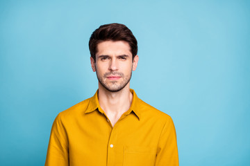 Photo of thoughtful strict manager standing confidently glancing at you candidly isolated over blue pastel color background