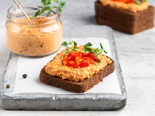 Healthy vegetarian rye bread open sandwich with vegetable pate (paste) decorated with chopped red...