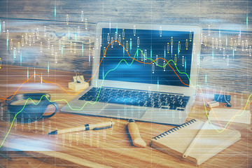 Multi exposure of chart and financial info and work space with computer background. Concept of...