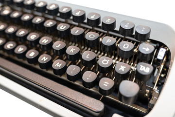 Classic, manual typewriter in white with a German keyboard layout, isolated on a white background with a clipping path.