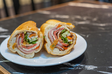 Vietnamese famous cuisine- Banh Mi, pork bacon sandwich and salad