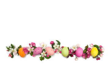 Easter decoration. Pink flowers apple tree and colored easter eggs on white background with space for text. Top view, flat lay