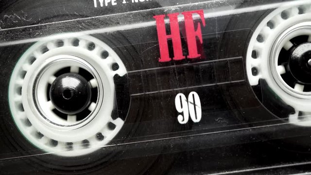 Retro audio tape copmact cassette is playing music.