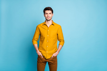 Photo of serious confident sctrict clever manager with hands in pockets of trousers staring intently at you watching isolated over blue pastel color background