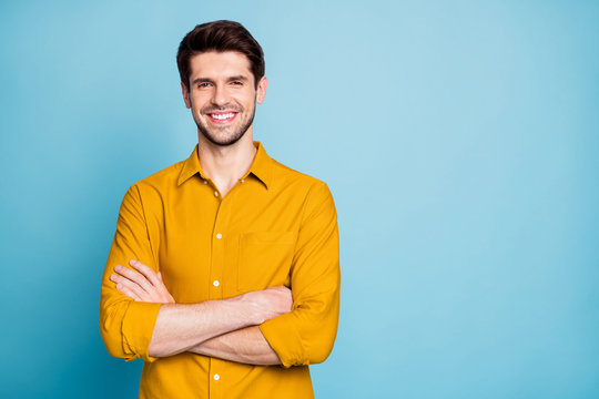 Photo of cheerful attractive handsome entrepreneur standing confidently with hands folded smiling beaming isolated over pastel color background