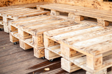 Furniture from a pallet. Pallet furniture with wheels. Modern interior detail