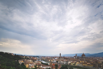 Beautiful bird's-eye view of Florence and the Arno river. Cloudy sky. Travel background.