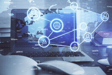 Computer on desktop with social network theme icon. Multi exposure. Concept of international connections.