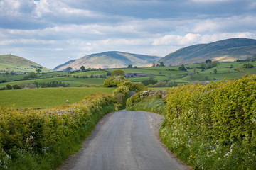 Rural road in the Yorkshire Dales landscape between Sedbergh and Beck Foot, Cumbria, England, UK