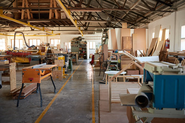 Wood and machinery in a large carpentry workshop