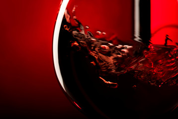 Red wine on red black background, abstract splashing. Macro shot