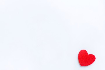 Red heart made of felt on a white background. Valentine's day symbol, holiday concept, minimal style. Top view with copy space for text.