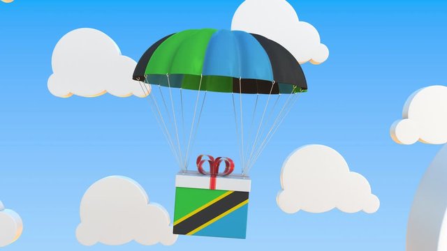 Carton with flag of Tanzania falls with a parachute. Loopable conceptual 3D animation