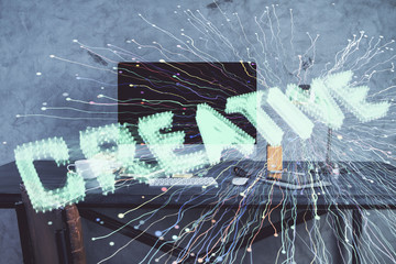 Desktop computer background in office and start up theme hologram drawing. Double exposure. Startup concept.