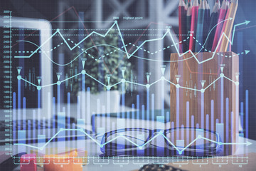 Financial chart hologram with glasses on the table background. Concept of business. Double exposure.